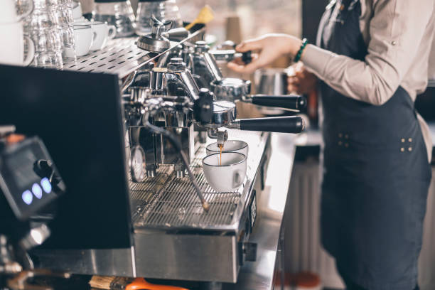 istock Coffee pouring into the cups while barista standing near 1152014221