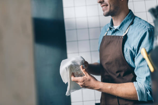 istock Close up of smiling man drying clean glass 1152014257