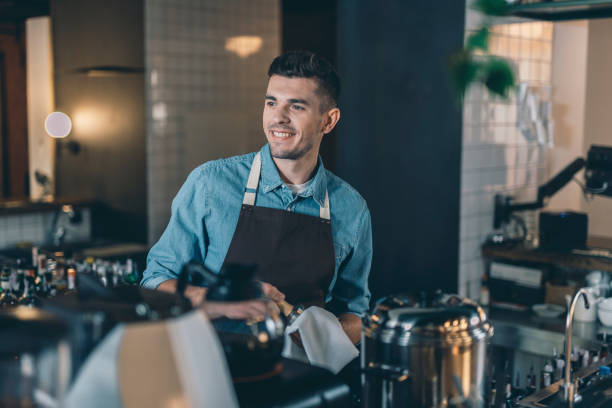 istock Confident barista looking away while cleaning tamper 1152014269