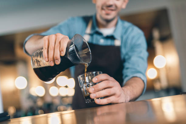 istock Selective focus of barista pouring coffee from drip decanter 1152014347