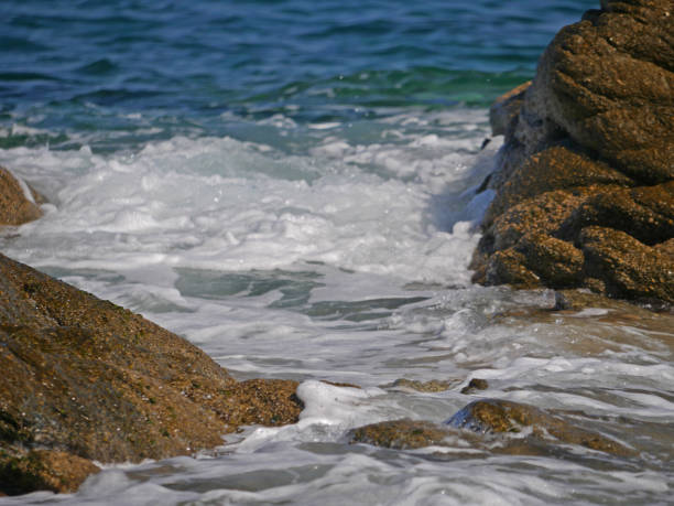 istock Waves crashing against the rock 1152015281