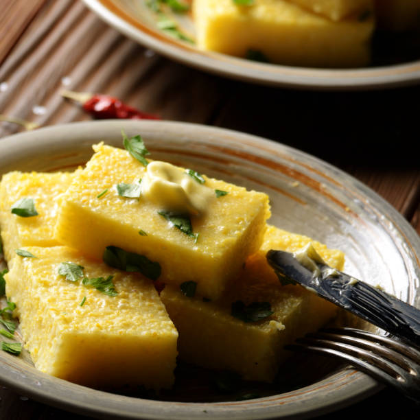 istock Polenta with butter and greens on clay dish on wooden rustic table 1152015332