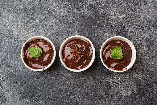 Chocolate paste with mint, cinnamon and anise on dark background with copy space
