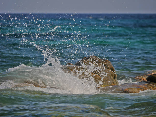 istock Waves crashing against the rock 1152015610