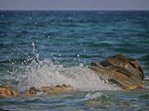 istock Waves crashing against the rock 1152015623