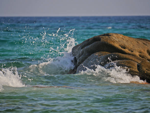 istock Waves crashing against the rock 1152015809