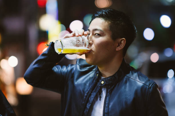 istock Portrait of handsome man while drinking beer at night 1152016210