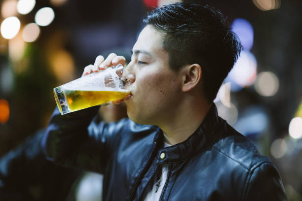 istock Portrait of handsome man while drinking beer at night 1152016255