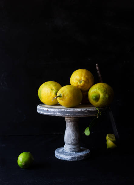 istock Still life with fresh yellow lemons on a stand 1152017050