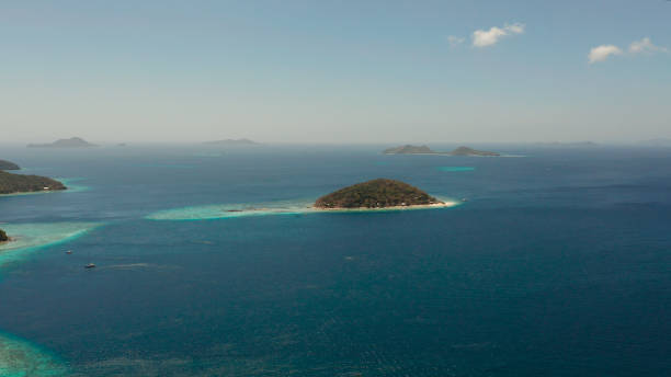 istock Small torpic island with a white sandy beach, top view 1152017194