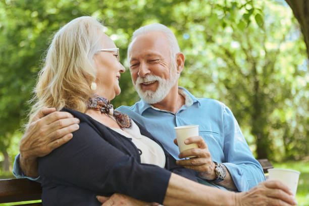 istock Senior couple drinking coffee outdoors in park 1152017854