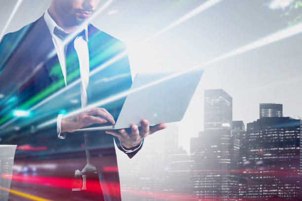 istock Double exposure of businessman working on laptop computer 1152018010