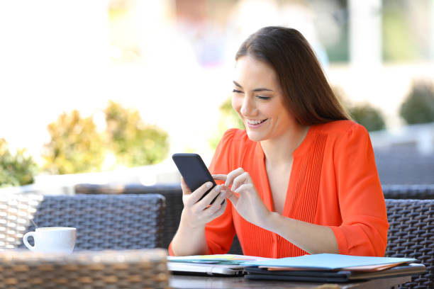 istock Happy entrepreneur uses a smart phone in a bar terrace 1152023299
