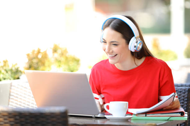 istock Happy student with headphones e-learning with a laptop 1152023336