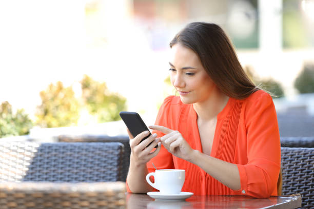 istock Serious woman is browsing a smart phone in a coffee shop 1152023558
