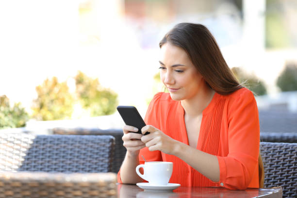 istock Serious woman is using a smart phone in a coffee shop 1152023565