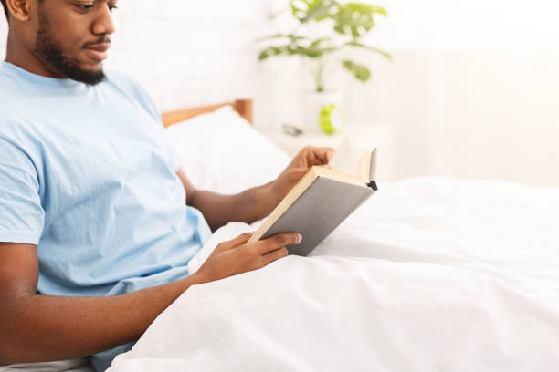 istock Black man studying business literature in bed 1152024131