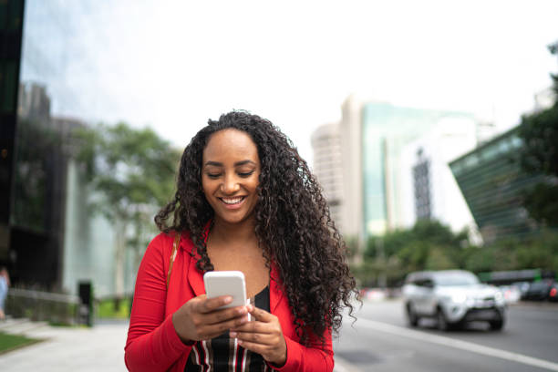 istock Businesswoman using cellphone in city street 1152024980