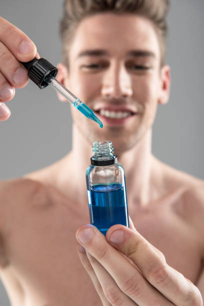istock Handsome young man holding vitamin serum and smiling 1152026489