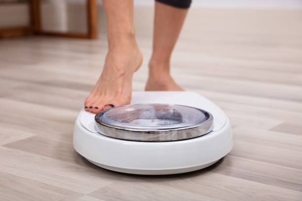 istock Human Foot Stepping On Weighing Scale 1152026587