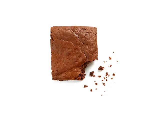 Homemade chocolate brownie with crumbs isolated on white background. Top view.