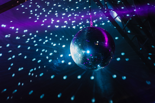 Shiny disco ball with lightning effects on stage
