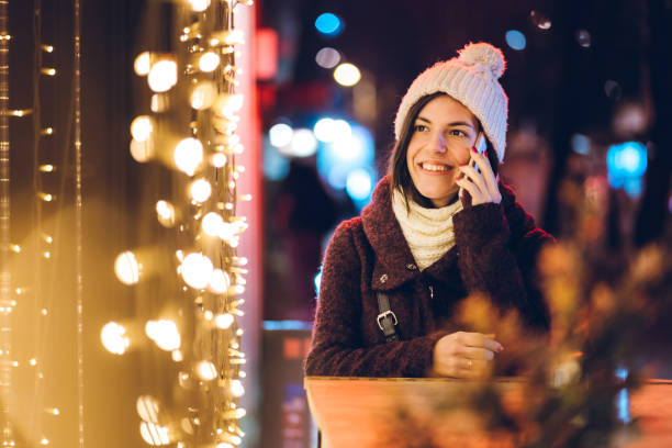 istock Woman using phone downtown at Christmas 1152031752