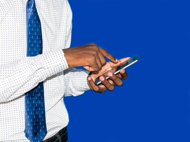 istock Business man black hand touching mobile phone. Focus on finger tips. Image 1152033444
