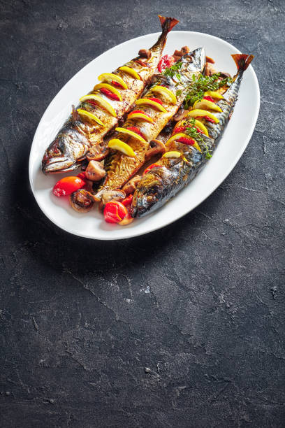 istock three whole grilled mackerel with lemon, tomatoes, mushrooms, spices and herbs. 1152035538