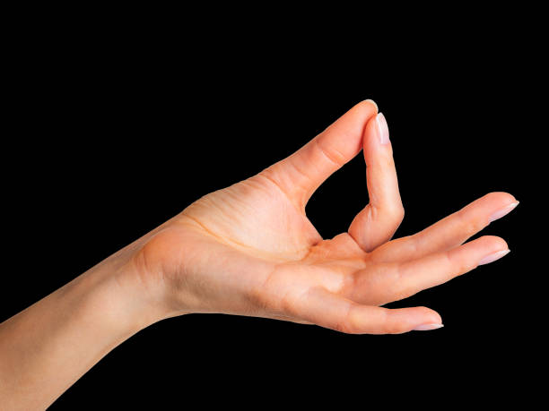 istock Woman hand showing mudra gesture or holding something. 1152036743