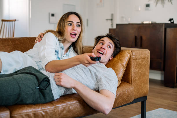 istock Happy couple watching tv 1152037245