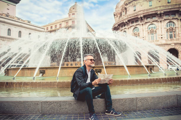 istock Tourist man with map on Piazza De Ferrari 1152038733
