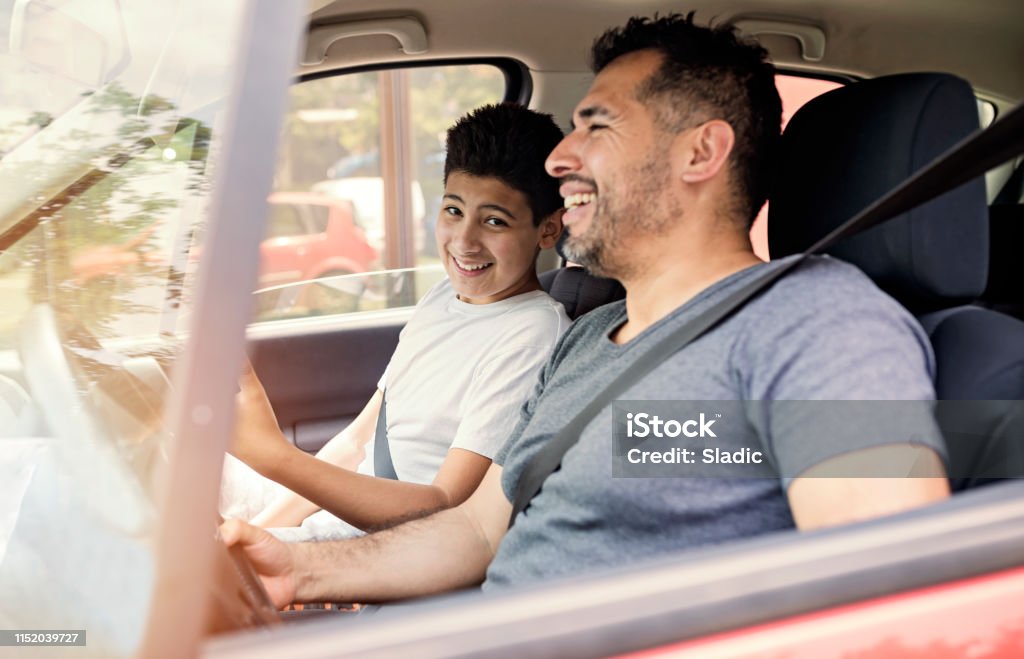 Spending day with dad Father and son spending quality time together.Traveling by car and using mobile phone. Father Stock Photo