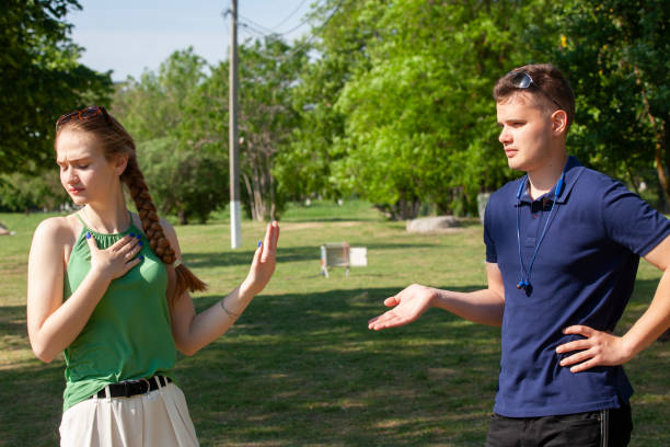 istock Young couple arguing while sitting on bench in park. Problems in relationship 1152039864