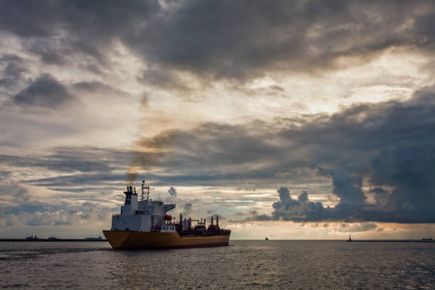 istock Sunset into the sea with the tanker ship Silhouette. 1152041994