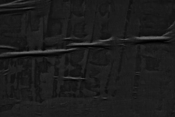 istock Dark black blank paper backgrounds creased crumpled surface old torn ripped posters grunge textures placard 1152042034