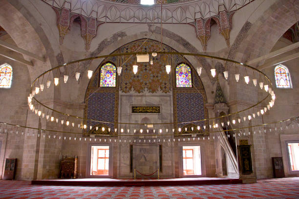 Edirne three Şerefeli Mosque, Uc Serefeli Mosque Edirne, Turkey - April 19, 2019: People pray in mosque called 3 şerefeli cami (Uc Serefeli mosque) Mosque in the center of city of Edirne, East Thrace, Turkey. The Üç Serefeli Mosque, named after its unusual minaret with three balconies (serefe), was built between 1438. unesco organised group stock pictures, royalty-free photos & images