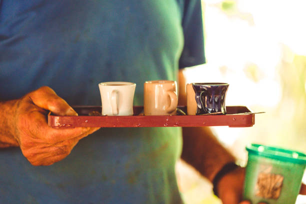 istock Man Serving Small Cups of Coffee on Tray 1152042268