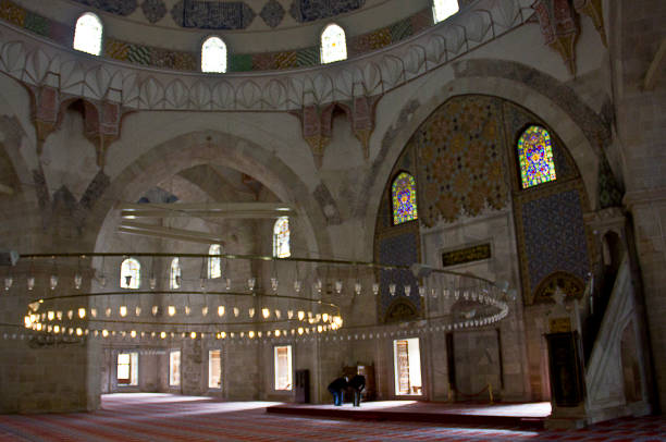 Edirne three Şerefeli Mosque, Uc Serefeli Mosque Edirne, Turkey - April 19, 2019: People pray in mosque called 3 şerefeli cami (Uc Serefeli mosque) Mosque in the center of city of Edirne, East Thrace, Turkey. The Üç Serefeli Mosque, named after its unusual minaret with three balconies (serefe), was built between 1438. unesco organised group stock pictures, royalty-free photos & images