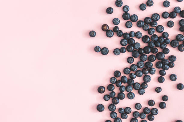 istock Blueberry on pink background. Flat lay, top view 1152043844