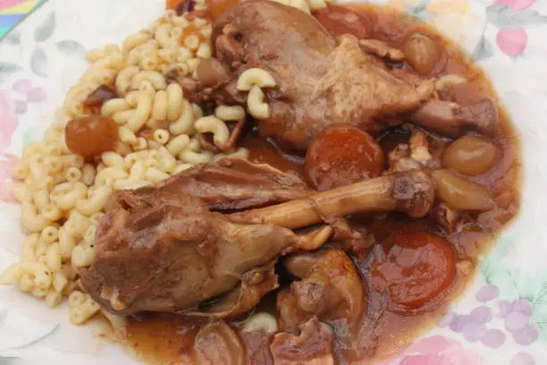 Coq au vin served with pasta   French cooking