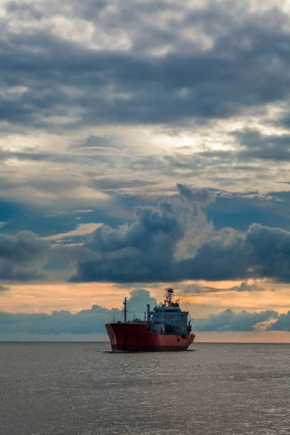 istock Sunset into the sea with the tanker ship Silhouette. 1152045222