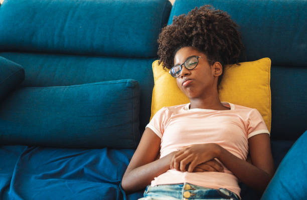 istock Teenage girl sleeping on sofa 1152046961
