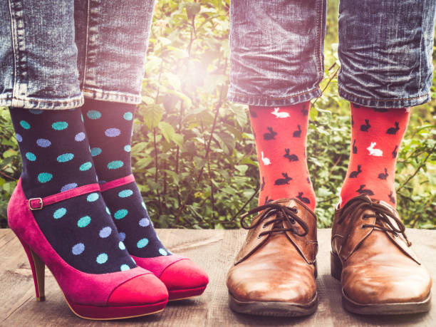 istock Men's and women's legs, bright socks. Close-up 1152047387