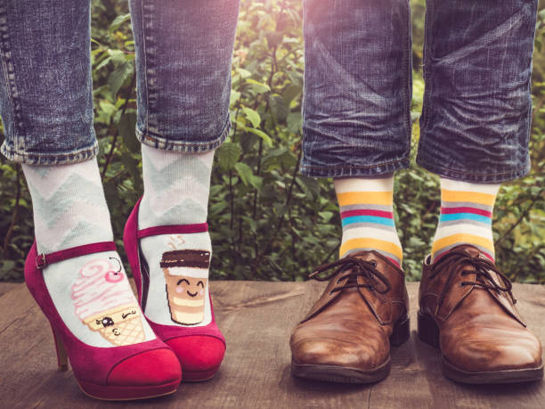 istock Men's and women's legs, bright socks. Close-up 1152048050