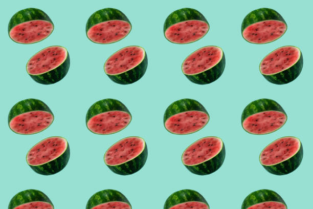 Pattern with watermelon sliced flying on pastel green background. Minimal fruit and summer concept.