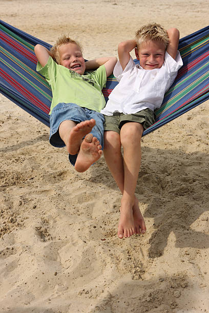 istock Smiling Young Boys In Hammock On The Beach 115204871