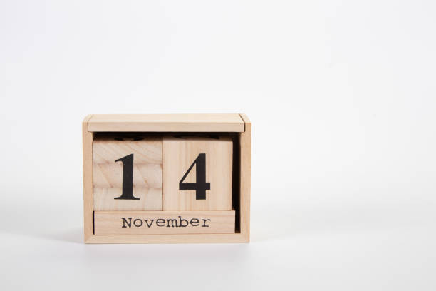 Wooden calendar November 14 on a white background close up