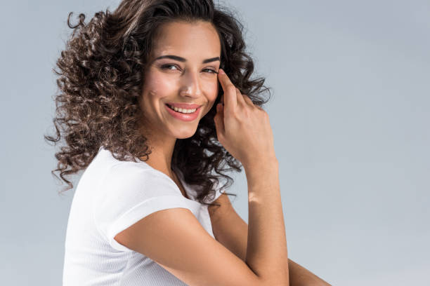istock Happy curly girl looking at camera isolated on grey 1152049776