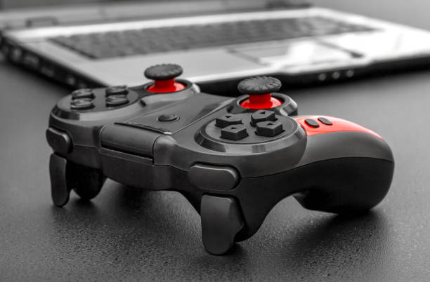 istock Gamepad with laptop on black background. 1152049811